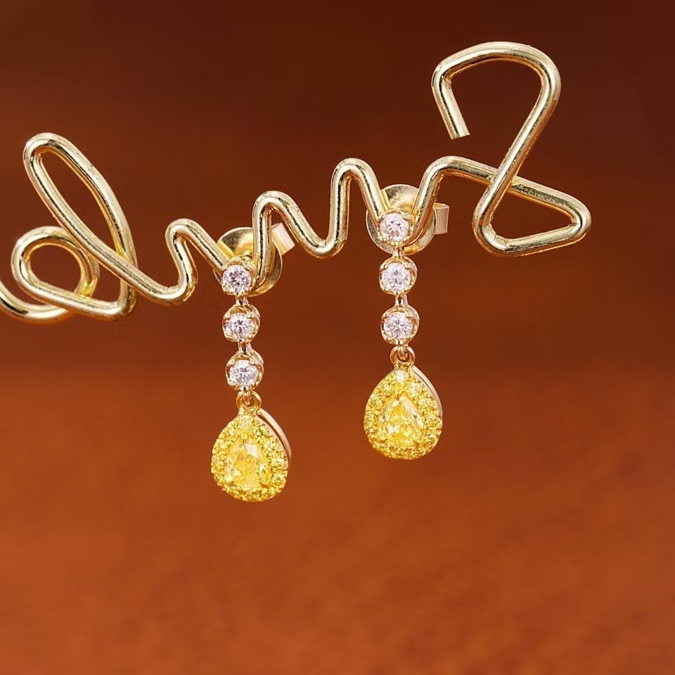 14k Gold 0.46 Ctw Natural Yellow Diamond & Diamond Earrings: Ref:230971040 // gold content:14k gold // main gemstone:yellow diamond // shape:pear // carat weight:0. 26ct // color:yellow // treatment:natural // // adjacent gemstone 2 : diamond // shape:round //
