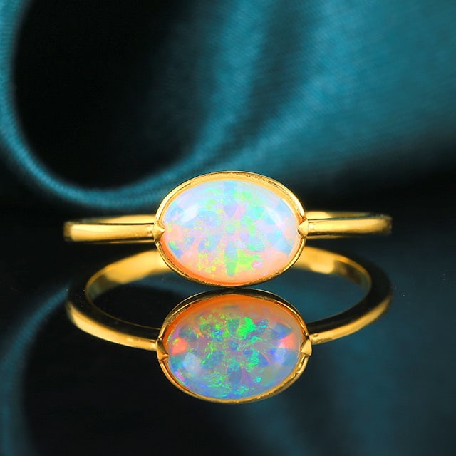 14k Gold 0.7 Ct Natural Opal Ring: Ref:230972114 // gold content:14k gold // ring size:7. 25us // // main gemstone:opal // shape:oval // carat weight:0. 7ct // color:white // treatment:natural // Low Estimate: 1500 Condition: New High