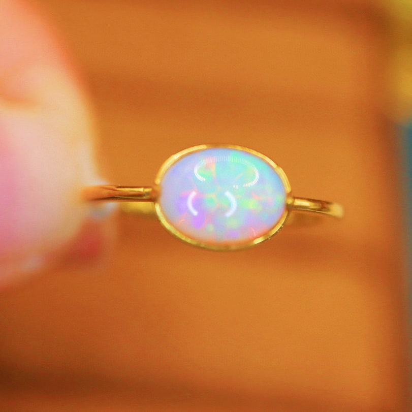 14k Gold 0.70 Ct Natural Opal Ring: Ref:230976117 // gold content:14k gold // ring size:7. 25us // // main gemstone:opal // shape:oval // carat weight:0. 70ct // color:white // treatment:natural // Condition: New Low Estimate: 1300.00