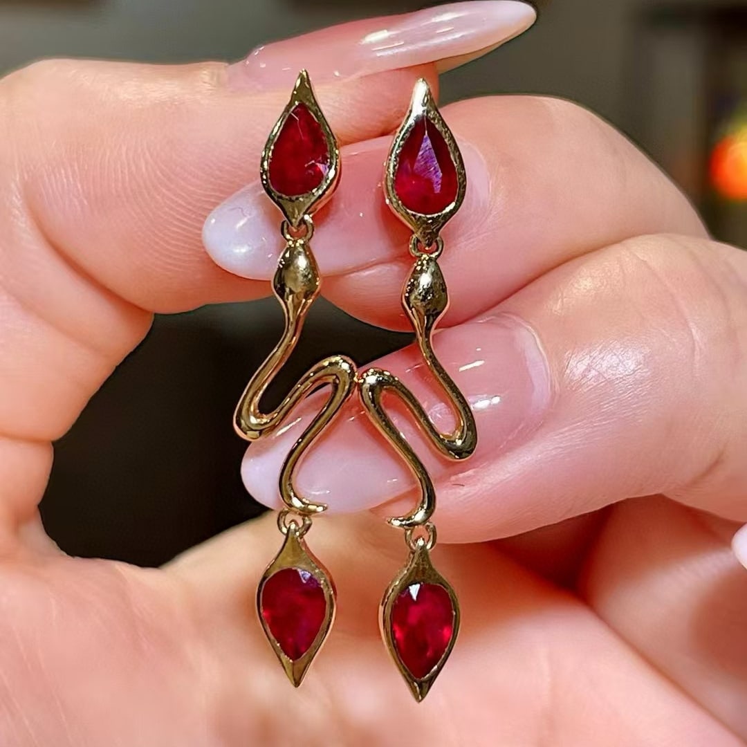 14k Gold 1.78 Ct Natural Ruby Earrings: Ref:230977230 // gold content:14k gold // main gemstone:ruby // shape:pear // carat weight:1. 78ct // color:red // treatment:natural // Condition: New Low Estimate: 3100.00 High Estimate: 4600.00