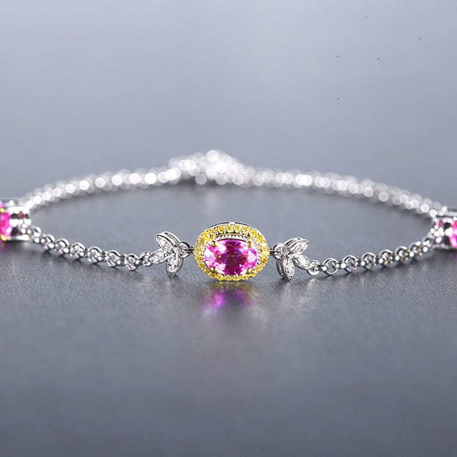 14k Gold 1.68 Ctw Natural Padparadscha Sapphire & Diamond Bracelet: Ref:230978250 // gold content:14k gold // main gemstone:padparadscha sapphire // shape:oval // carat weight:1. 58ct // color:orangish pink // treatment:natural // // adjacent gemstone 2 : diamond //