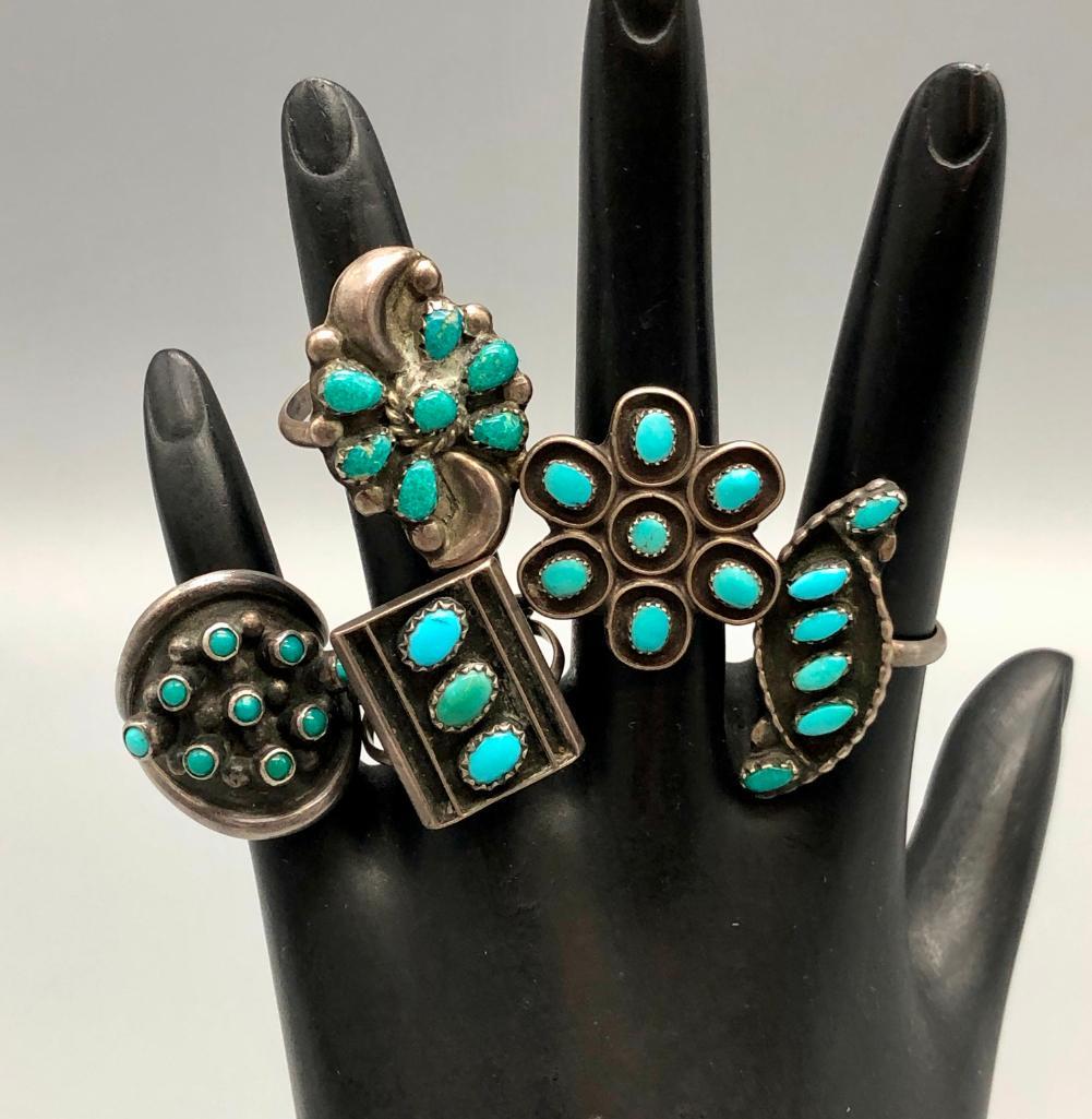 Group of Five Fred Harvey Era Turquoise Cluster Rings: Offered for sale is a group of five Fred Harvey era turquoise cluster rings. These rings each feature petit-point and snake-eye turquoise in different clusters and designs surrounded by pleasing silve