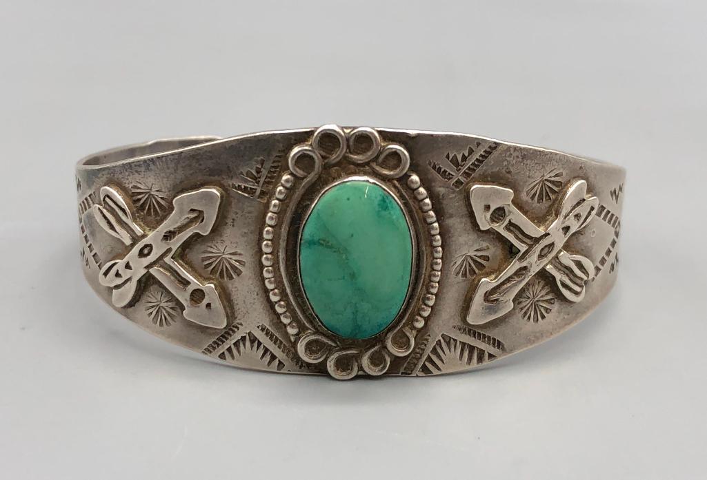 Fred Harvey Era Bracelet with Crossed Arrows, Cactus and Snakes: Available for your bidding enjoyment is a Fred Harvey era bracelet with crossed arrows, cactus and snakes. This bracelet features a green turquoise cabochon at the center complete with crossed arrow a