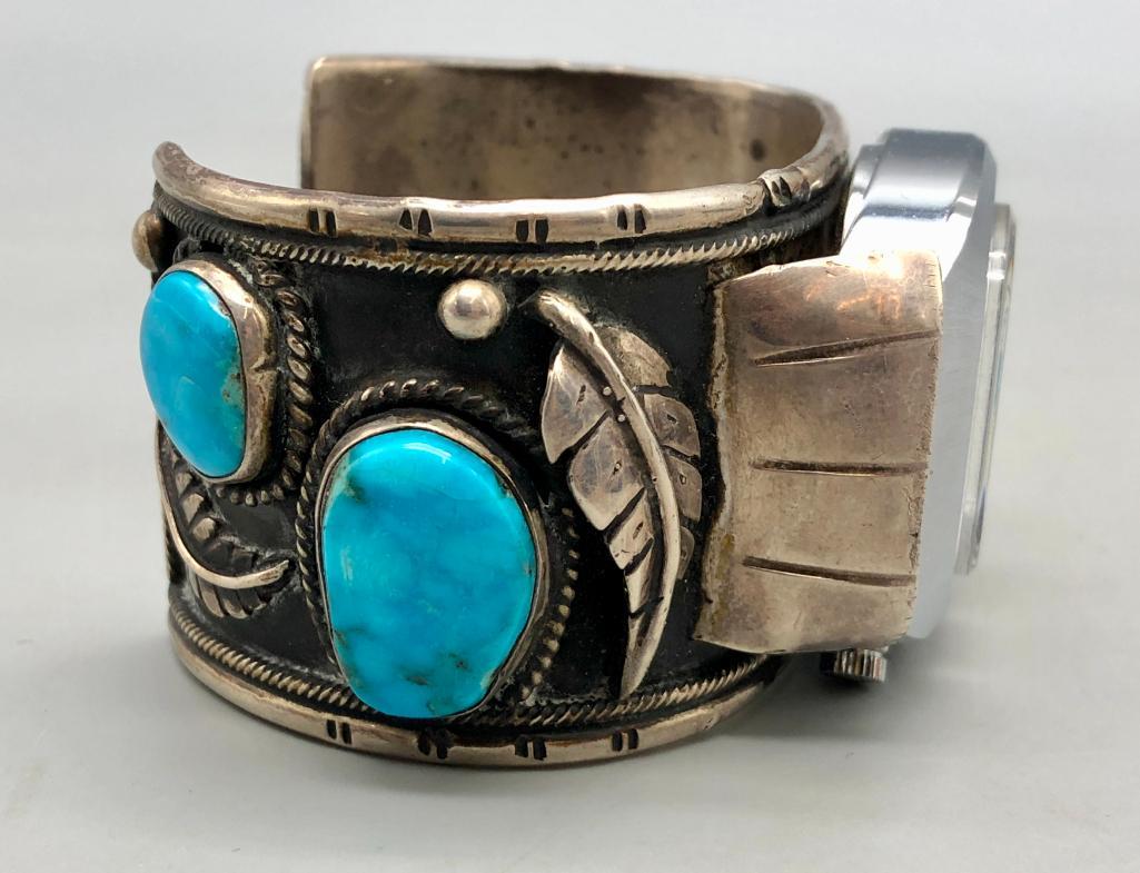 Vintage Four Stone Turquoise Watch Cuff: Available here is a vintage four stone turquoise watch cuff. This stunning piece features a great sterling silver cuff with two turquoise cabochons on either side and surrounding silverwork of twisted