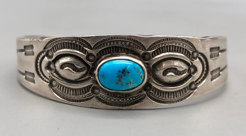 Vintage Turquoise and Sterling Silver Bracelet: For your consideration we present a vintage turquoise and sterling silver bracelet. This bracelet features a bright turquoise cabochon in a smooth setting. The cuff is adorned with hand stamped decora