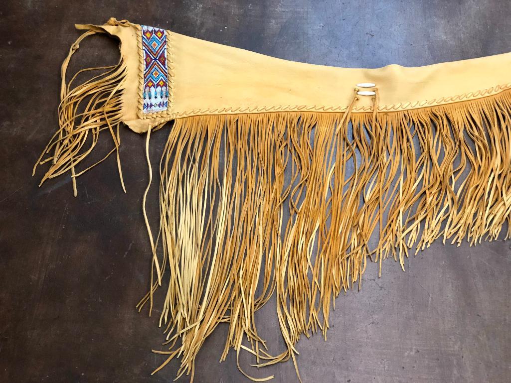 Beaded Rifle Scabbard: Available here for your consideration is a beaded deer skin rifle scabbard. This item features beadwork with vivid colors of red, shades of blue, yellow, orange, and white, which are arranged in a tra