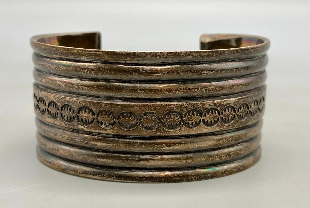 Navajo Guild Sterling Silver Bracelet: Offered here is a Navajo Guild sterling silver bracelet. This exquisite bracelet features a sterling silver cuff with nice ridges, filework and hand stamped designs. Add this Navajo Guild bracelet to 