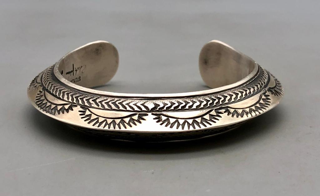 Hefty Sterling Silver Bracelet by Robert Johnson: Available here for your bidding enjoyment is a hefty sterling silver bracelet by Robert Johnson. This great piece has a triangular-shaped band, made of hefty sterling silver, with great hand stamping