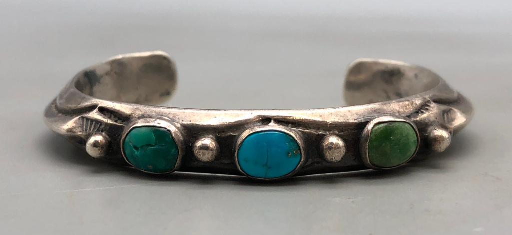 Older Three Stone Ingot Bracelet: Offered here is an older three stone ingot bracelet. This wonderful little bracelet has three cabochons of turquoise in different shades of blue and green. Silver dots accent the turquoise on a dainty