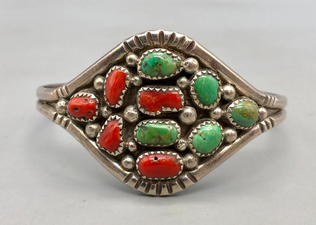 Vintage Turquoise and Coral Bracelet: Offered here is a vintage turquoise and coral bracelet. This lovely bracelet features five turquoise cabochons and five coral cabochons, arranged in a diamond shaped sterling silver band. Complete you