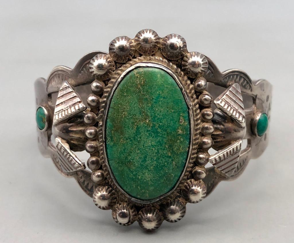 1930-40s Era Turquoise and Sterling Silver Bracelet: Featured here for your bidding enjoyment is a 1930-1940's era turquoise and sterling silver bracelet. This incredible piece features one central larger turquoise cabochon, and two smaller ones on eith