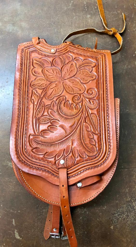 Pommel Saddle Bags with Hidden Holster: Available here for your consideration are a nice set of Pommel saddle bags with a hidden holster under one flap. These saddle bags feature hand tooled leather in various patterns. Add this to your col