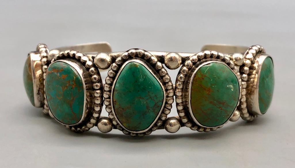 Five Stone Turquoise Bracelet: Available here is a five stone turquoise bracelet. This fabulous bracelet has five wonderful green turquoise cabochons in a row on a silver three wire terminal. Silver dots compliments this piece nice