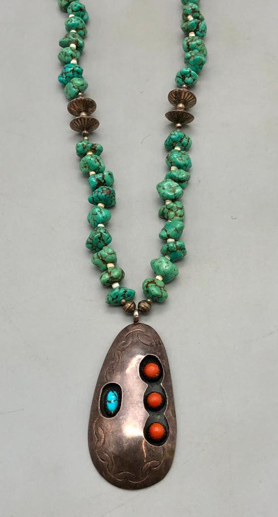 Vintage Turquoise and Coral Heishi and Sterling Silver Bead Necklace: In this lot is a vintage turquoise and coral heishi and sterling silver bead necklace. This piece features a single turquoise chunk strand with a shadow box pendant. The pendant is rather unique, hous