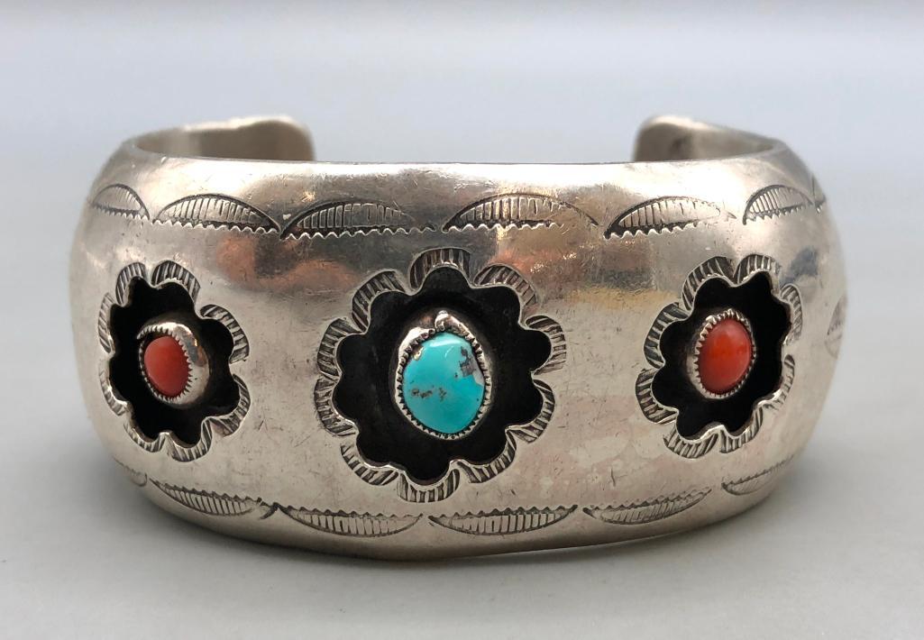 Shadowbox Style Coral and Turquoise Bracelet: Offered here is a shadowbox style coral and turquoise bracelet. This truly incredible shadowbox style cuff bracelet has two coral and one turquoise cabochons in floral shaped shadowbox cutouts. Hand s