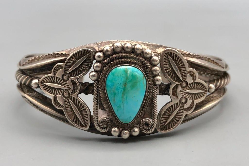 Nice Older Handmade Bracelet: Presented here is a nice, older handmade bracelet. This bracelet features a stunning turquoise cabochon with twisted wire and silver accents surrounding it. The cuff features a three wire terminal, on
