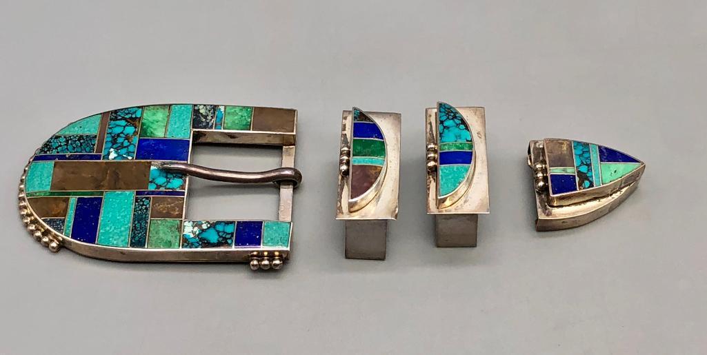 Four Piece Multi Stone Ranger Buckle Set: Presented for sale in this lot is a high grade turquoise and lapis four piece buckle set. This is a vibrant buckle set that features inlay work of turquoise, lapis and other stones, with fine silverwo