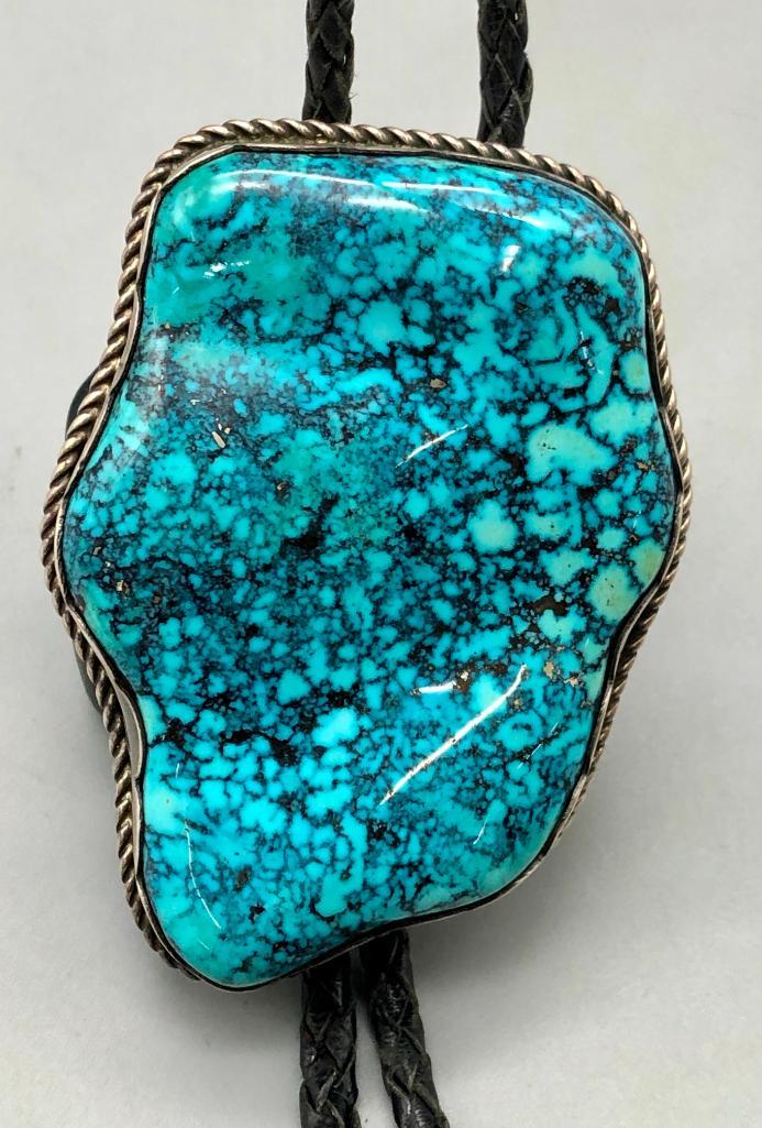 Vintage Large Stormy Mountain Turquoise and Sterling Silver Bolo Tie - Mike Platero: Offered in this lot is a vintage large Stormy Mountain turquoise and sterling silver bolo tie by Mile Platero. This stunning slide features a larger turquoise cabochon in the center (possibly from the