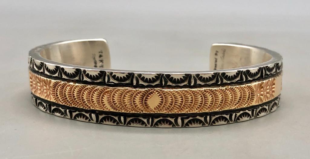 Sterling Silver and 14K Gold Hand Stamped Bracelet by Marc Antia: For your bidding enjoyment we present a sterling silver and 14K gold hand stamped bracelet by Marc Antia. This beautiful bracelet features a 14K gold middle band with hand stamped designs resting on a