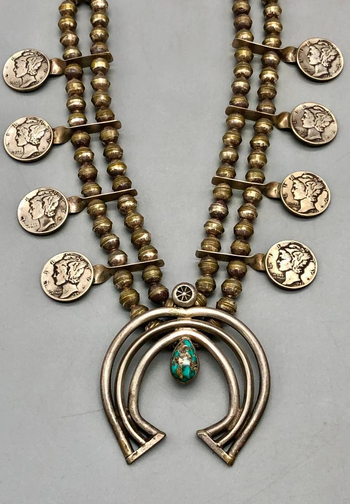 Coin Themed Squash Blossom Necklace: For your bidding pleasure today is a coin themed squash blossom necklace. Showcased on this necklace is a three wire naja with a turquoise cabochon. The two strands of sterling silver beads hold eight