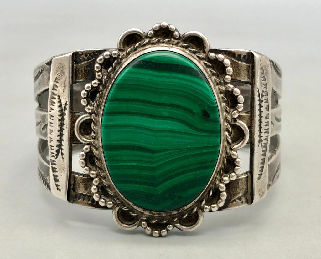 Vintage Sterling Silver Cuff Bracelet: For your bidding enjoyment we present a vintage sterling silver cuff bracelet. This beautiful bracelet features a central malachite cabochon (which is probably a newer replacement) displayed in a hand
