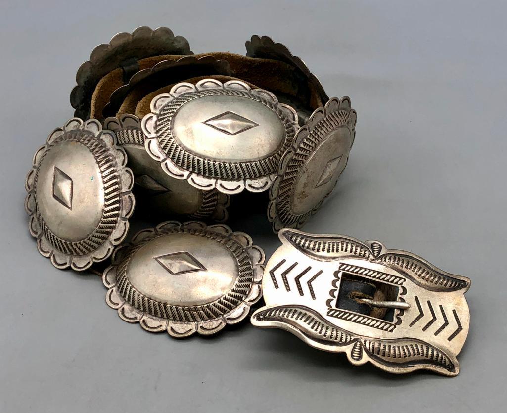 Vintage Sterling Silver Concho Belt: Offered here for your bidding pleasure is a vintage sterling silver concho belt. The belt has nine oval conchos and a rectangular buckle, each with hand stamped designs, filework, repousse bump outs, 