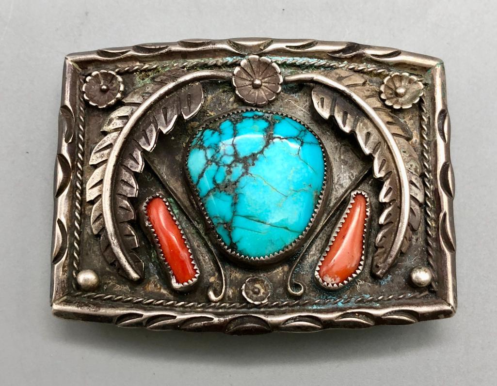 Vintage Turquoise and Coral Belt Buckle: Offered here for your consideration is a vintage turquoise and coral belt buckle. This stunning buckle has two coral and one turquoise cabochon, both in silver sawtooth bezels. Silverwork of silver le