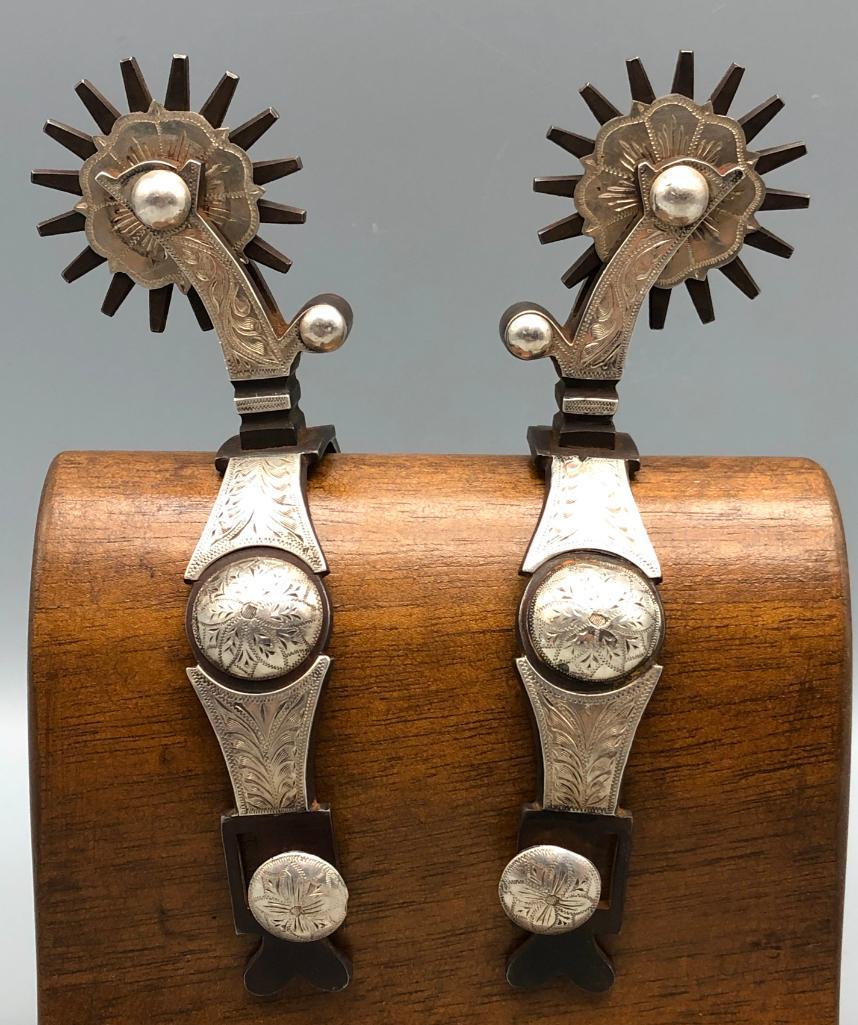 Engraved Button Spurs by John Wilson: Available here for your consideration are a pair of engraved, silver overlay, button pattern spurs by John Wilson. John is an Oregon rancher and he attended the Elmer Miller Bit and Spur School. He do