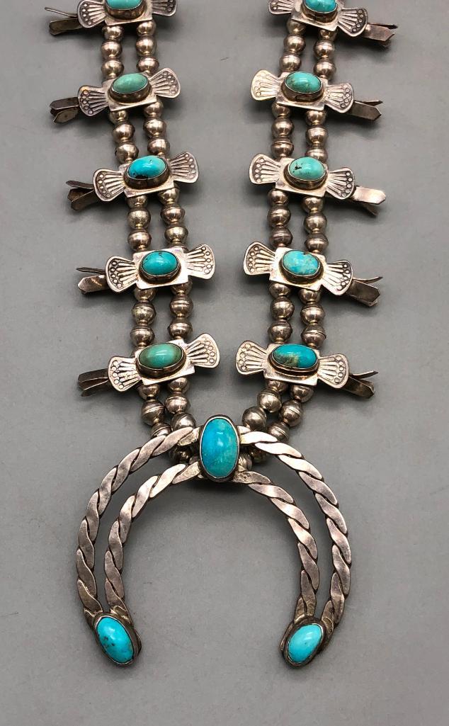 Vintage Box Bow Style Squash Blossom Necklace: Offered here for your consideration is a vintage box bow style squash blossom necklace. This necklace features a lovely naja highlighted with three turquoise cabochons all resting in smooth silver bez