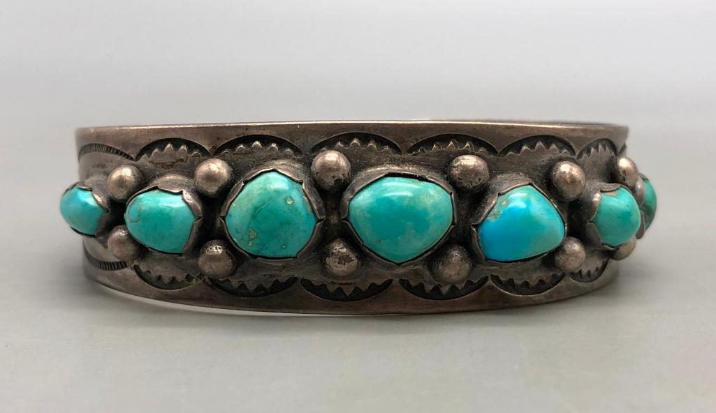 Vintage Seven Stone Turquoise & Sterling Silver Bracelet: For your bidding enjoyment we present a vintage seven stone turquoise and sterling silver bracelet. This beautiful bracelet features seven turquoise cabochons displayed in handmade scalloped silver be