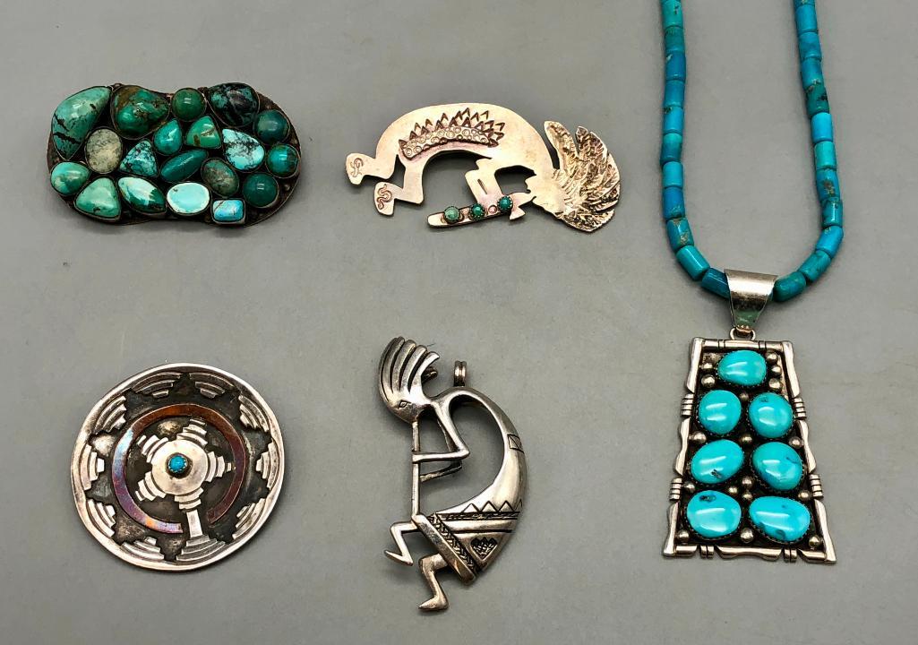 Group of Pendants And Pins: Available here are a group of pendants and pins. This lot features a little bit of variety for everyone. These pendants and pins feature Kokopelli designs, turquoise cabochons resting in smooth silver