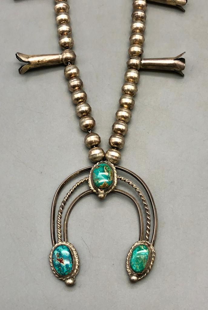 Turquoise And Sterling Silver Style Squash Blossom Necklace: For your bidding pleasure today is a turquoise and sterling silver style squash blossom necklace. Showcased on the naja is three turquoise cabochons resting in smooth silver bezels. The settings are s