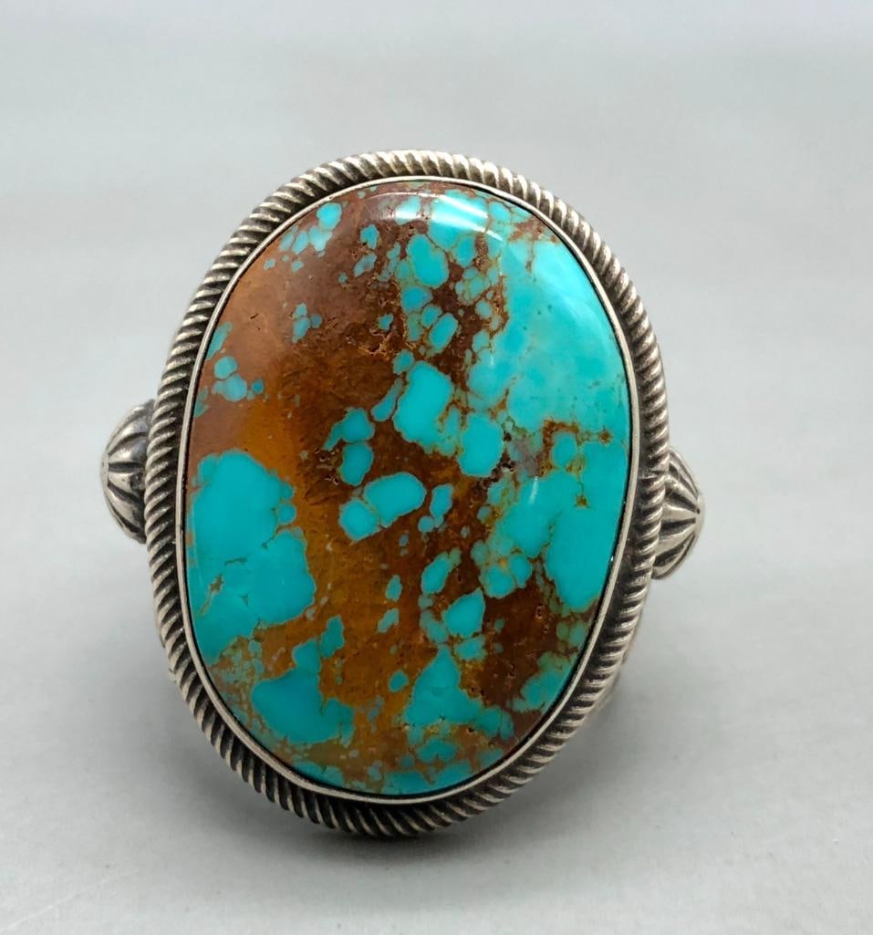 Statement Turquoise Ring by Richard Jim: Offered here for your consideration is a statement turquoise ring by Richard Jim. This great ring features a large central turquoise cabochon resting in a smooth silver bezel and surrounded by twisted