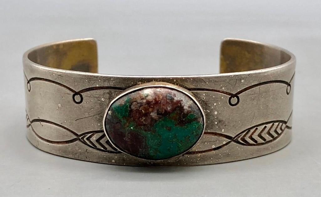 Vintage Sterling Silver And Turquoise Bracelet: For your enjoyment we present a vintage sterling silver and turquoise bracelet. This beautiful bracelet features a central natural turquoise stone displayed in a smooth silver bezel. The stone shows c