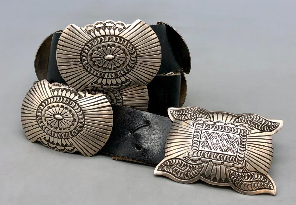 Hefty Sterling Silver Concho Belt: Offered here for your consideration is a hefty sterling silver concho belt. The belt has nine oval shaped conchos and one rectangular buckle each with deep stamped designs and darkened textured areas 