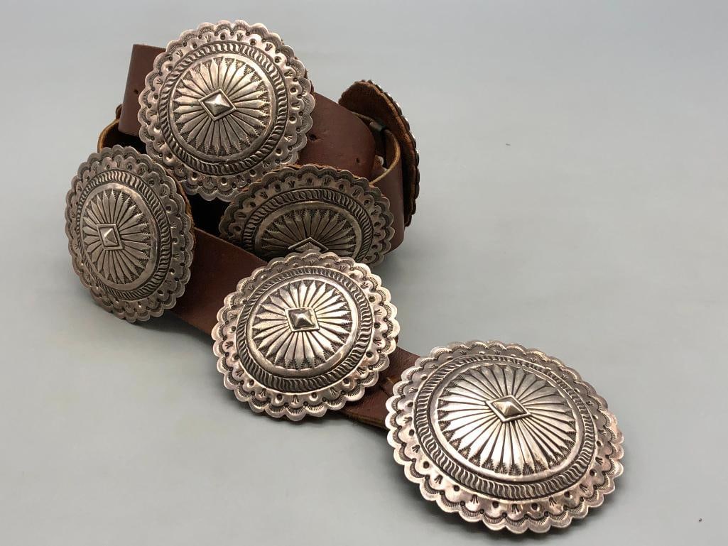 Eye-Catching Sterling Silver Concho Belt: Offered here for your consideration is an eye-catching sterling silver concho belt. The belt has eight conchos and one buckle each with hand stamped designs, deep stamped and darkened lines,