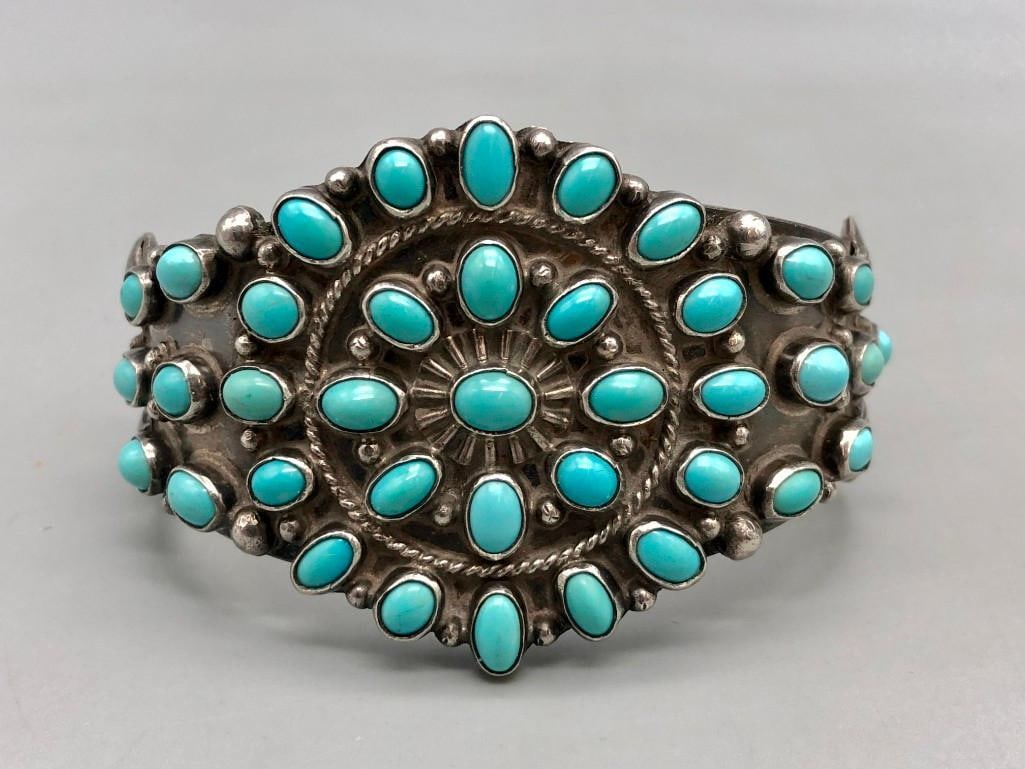 Unique Turquoise Cluster Bracelet: Available here for your bidding enjoyment is a unique turquoise cluster bracelet. This wonderful piece has a circular face, with two rows of turquoise cabochons (creating a cluster), and matching turq