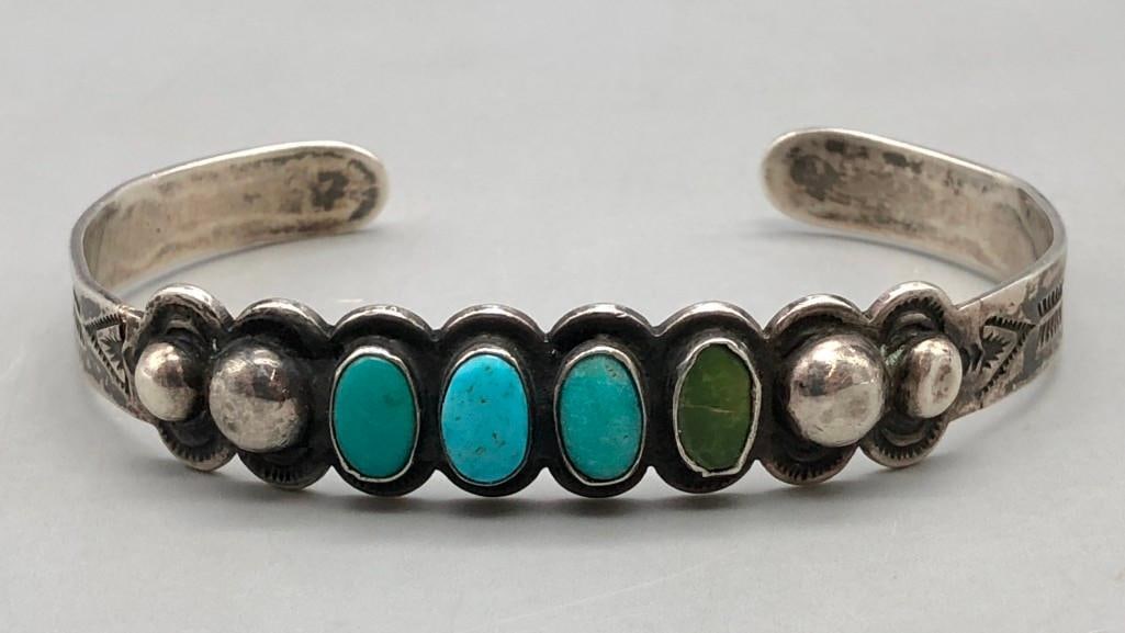 1930s Era Four Stone Natural Turquoise Bracelet: For your bidding enjoyment we present a 1930s era four stone natural turquoise bracelet. This lovely bracelet features four stones displayed in handmade smooth silver bezels on a darkened background. 
