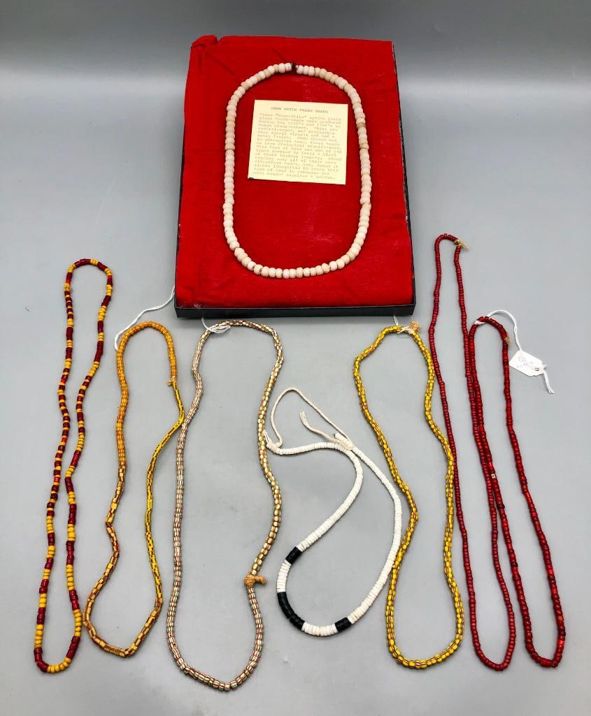 Group of Trade Bead Necklaces: Presented here is a group of trade bead necklaces set in display cases. Native American trade bead jewelry and adornments were popular with tribes across North America, and used through trade beginnin