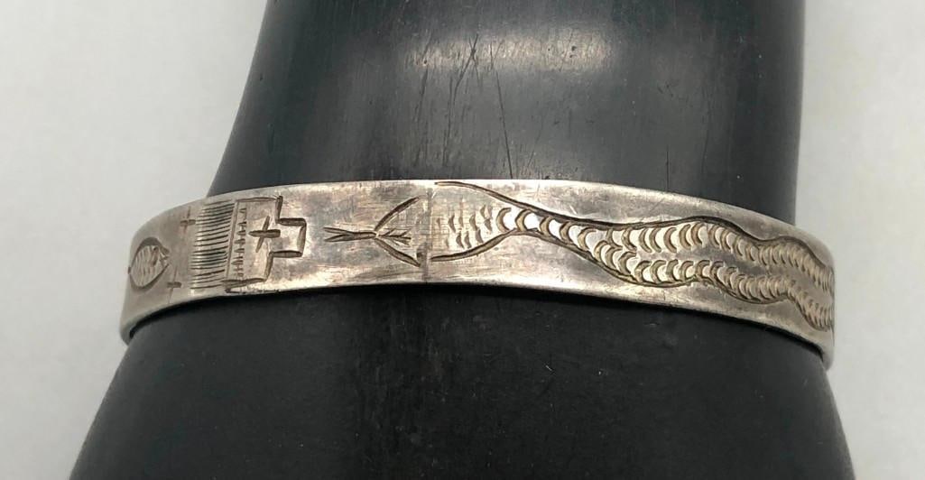 Snake and Tadpole Themed Bracelet Circa 1920s - 1930s: For your enjoyment we present a snake and tadpole themed bracelet circa 1920s - 1930s. This great older sterling silver bracelet features stamped designs of a frog, dragonfly, a church, and rain cloud