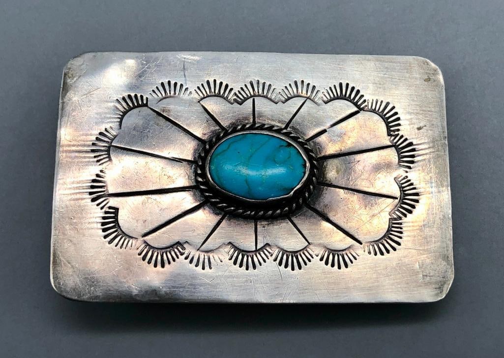 Vintage Turquoise And Sterling Silver Belt Buckle: Available here in this lot is a vintage turquoise and sterling silver belt buckle. This classic belt buckle features a central turquoise cabochon resting in a smooth silver bezel surrounded by twisted