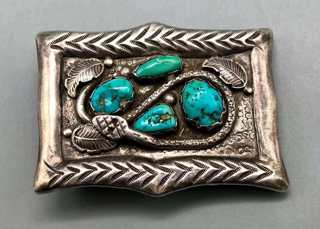 Vintage Zuni Snake Themed Turquoise Buckle: Available here in this lot is a vintage Zuni snake themed turquoise buckle. This sterling silver belt buckle features four turquoise nugget style cabochons resting in handmade silver bezels surrounded