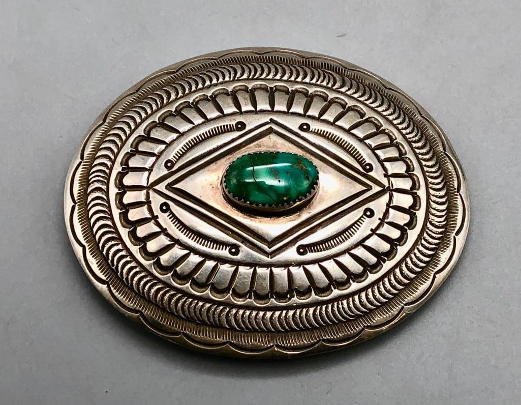 Sterling Silver Belt Buckle With A Nice Turquoise Stone: Available here in this lot is a sterling silver belt buckle with a nice turquoise stone. This sterling silver belt buckle features a central turquoise cabochon in a handmade sawtooth bezel. Various ha