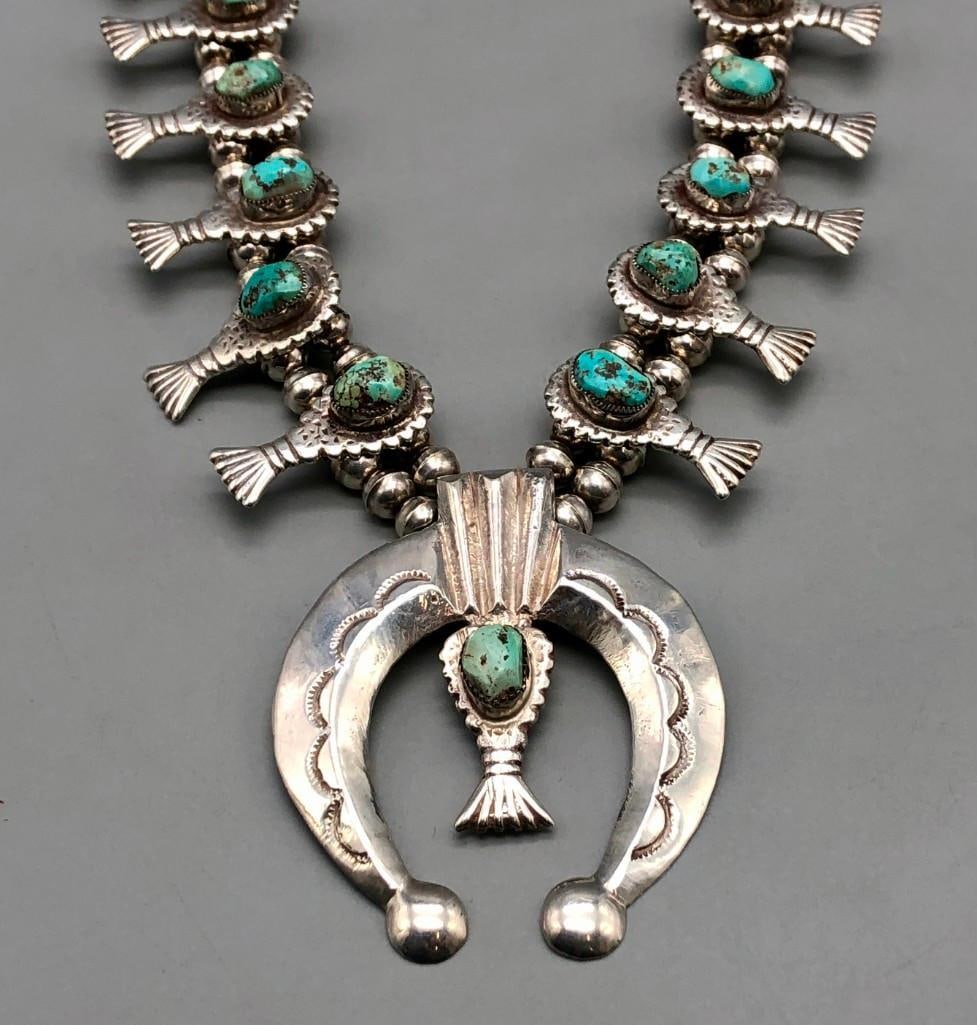 Vintage Turquoise And Sterling Silver Squash Blossom Necklace: Offered here for your consideration is a vintage turquoise and sterling silver squash blossom necklace. This necklace features a lovely crescent shaped naja highlighted with one natural turquoise nugg