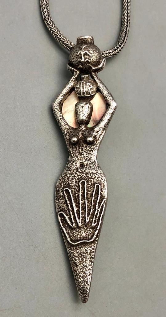 Tufa Cast Pendant By Anthony Lovato: Offered here for your consideration is a tufa cast pendant by award winning artist, Anthony Lovato. This necklace features a tufa cast figure of a woman carrying a pot of water on her head with a lar