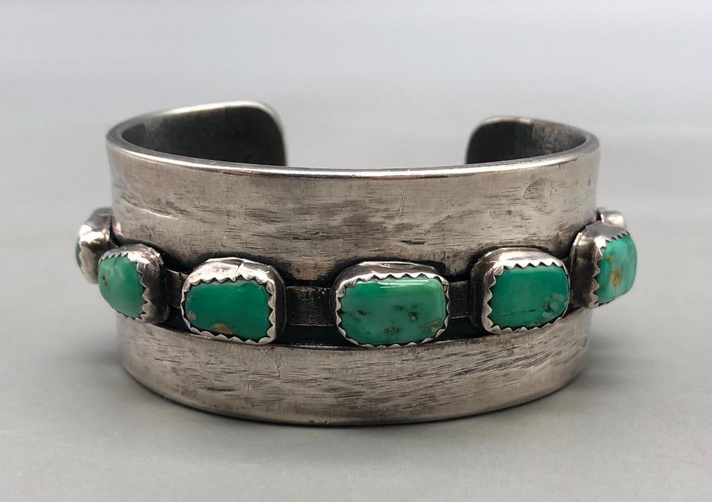 Ingot Seven Stone Green Turquoise Bracelet : For your bidding enjoyment we present an ingot seven stone green turquoise bracelet. This bracelet features seven green turquoise cabochons resting in handmade silver bezels displayed on a smooth silv