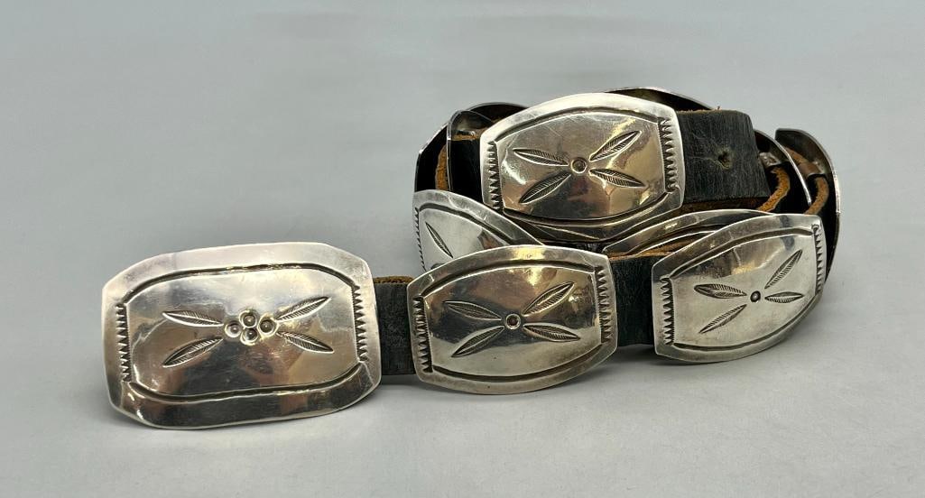 Sterling Silver Concho Belt By James Toadlena: Offered here for your consideration is a sterling silver concho belt by James Toadlena. The belt has eleven conchos and one buckle each with lovely stamped designs and lines darkened for contrast and 
