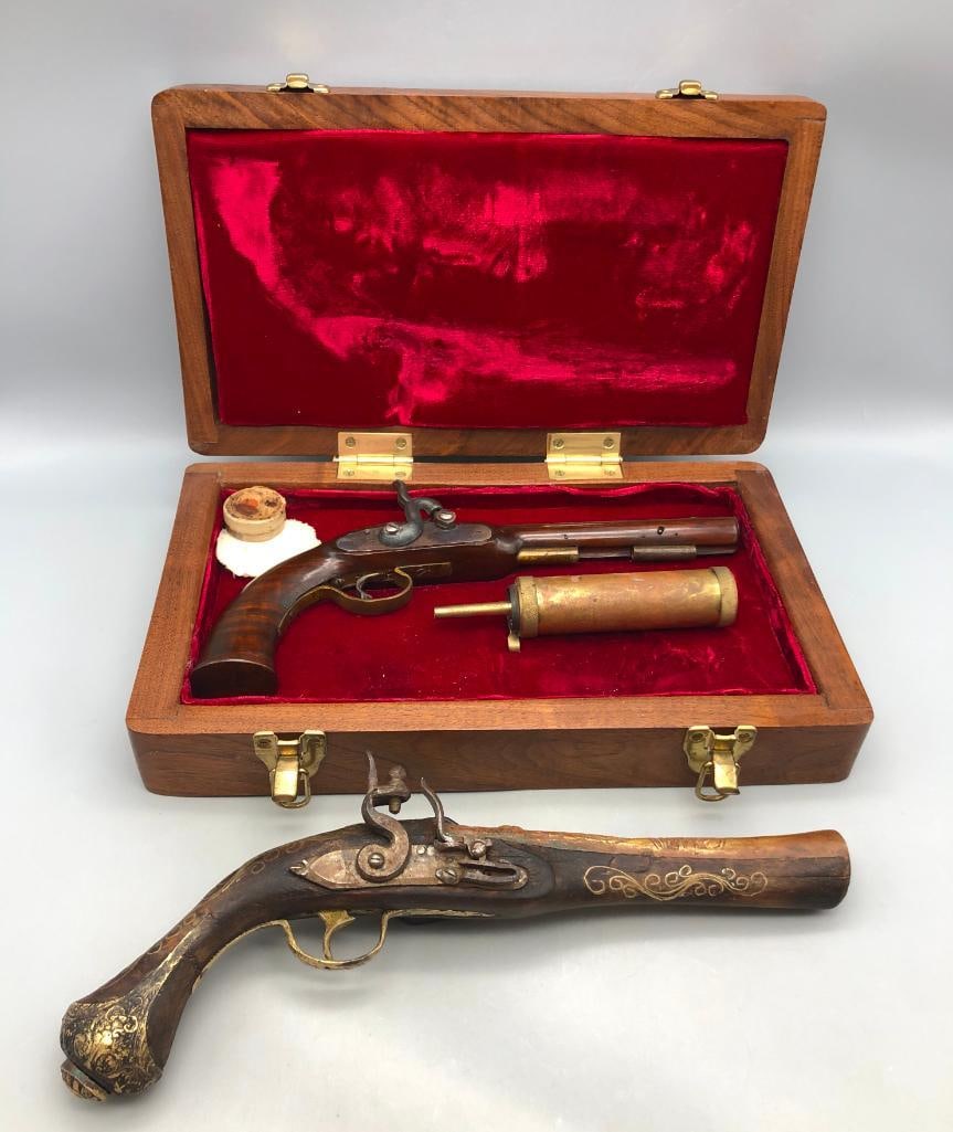 One Flint Lock And One Percussion Cap Pistol With Accessories: Offered here for your consideration are two black powder single shot pistols. One is a flintlock blunderbuss style and the other is a percussion cap. The percussion pistol has an eight inch barrel and