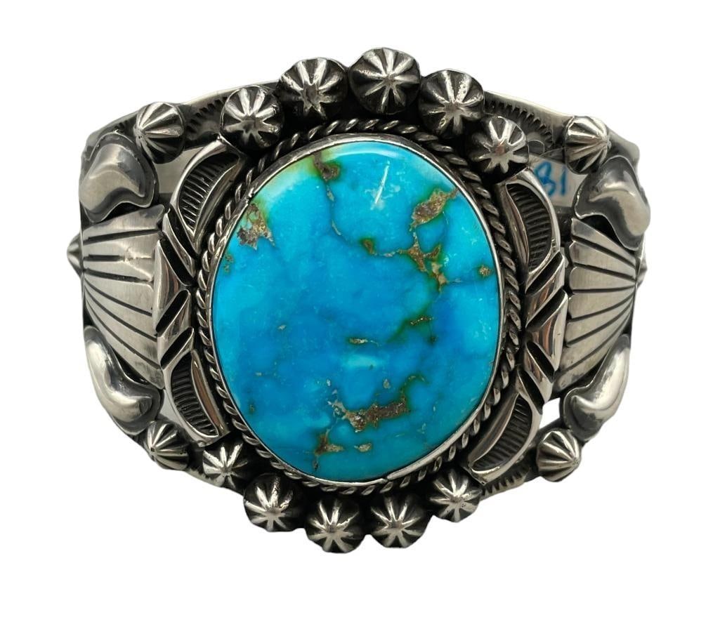 Hefty High Grade Turquoise Bracelet By Rick Werito: For your bidding enjoyment we present a hefty high grade turquoise bracelet by Rick Werito. This bracelet features a lovely blue central turquoise cabochon with nice matrix resting in a smooth silver 