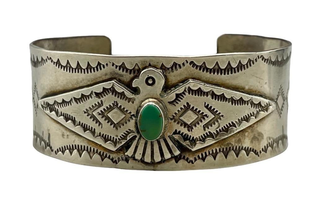 Vintage Thunderbird Themed Bracelet: For your bidding enjoyment we present a vintage Thunderbird themed bracelet. This bracelet features a nice hand stamped Thunderbird applique with one small oval turquoise cabochon resting in a smooth 